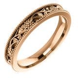 Floral wedding band with intricate vine and bead pattern detailing around the band.