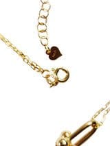 Close-up of an 18k Yellow Gold Linear Necklace 18 Inches Long clasp with an attached chain link and a small heart charm.