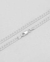 Close-up of a Fine Silver 925 Chain Italy Pure Silver Plated Over 925 with a lobster clasp lying on a light surface.