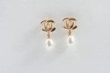 A pair of 18k Yellow-Gold Double CC-Design Earrings with a single dangling pearl on each.