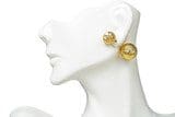 White mannequin head wearing large, 18k Yellow-Gold Floating Stud Earrings.