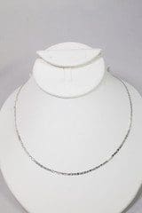 A 14k gold plated white gold chain is displayed on a white bust stand against a plain background.