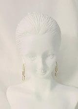 White bust of a woman with minimal facial features, adorned with 18k Yellow-Gold Dainty Linear Earrings 1.20 Inches L. Bust is set against a white background.
